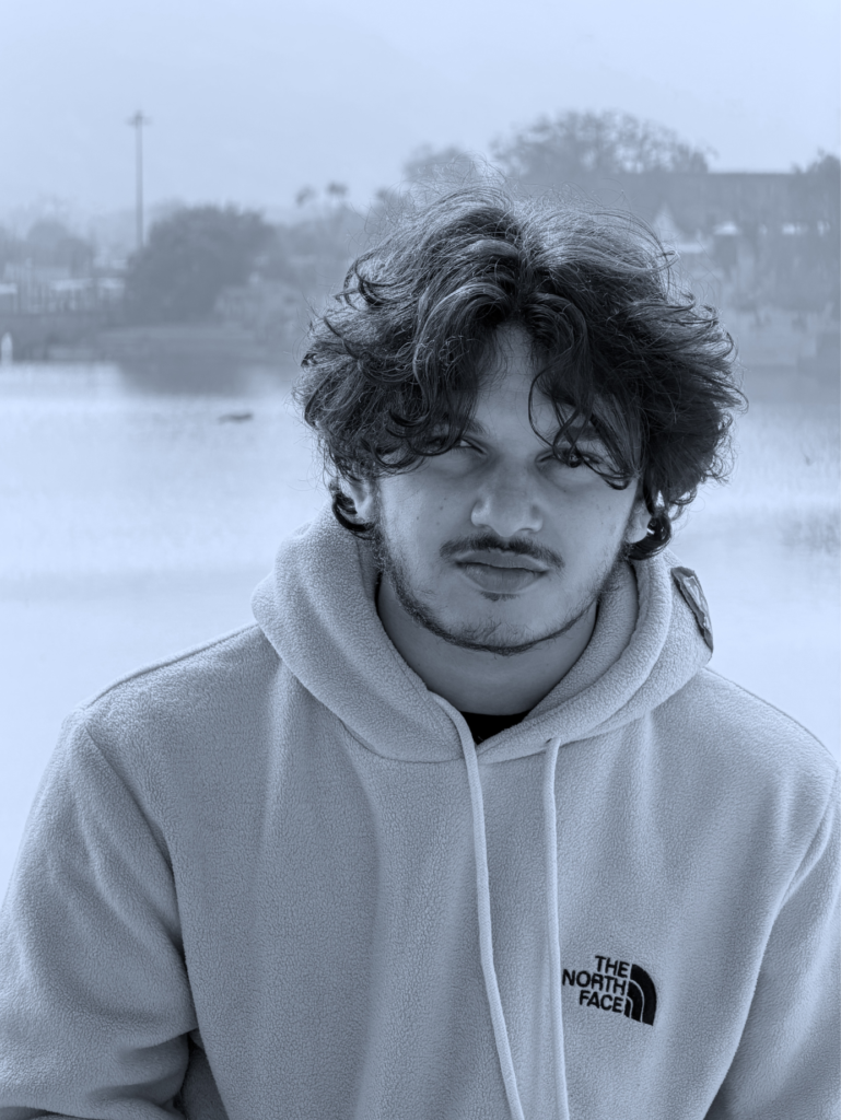 Headshot of Mohammed Yasin, a digital marketer, wearing a light-colored hoodie against a soft outdoor background.